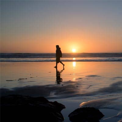 Someone walking on beach in sunset