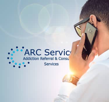  A person on cell phone with ARC logo.