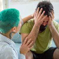  a woman consoling a man.