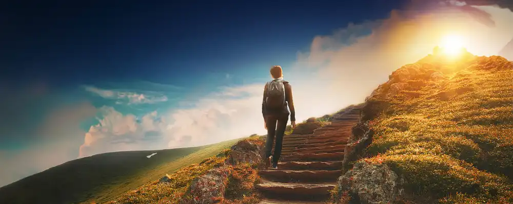  A person going up a stairway toward the sun.