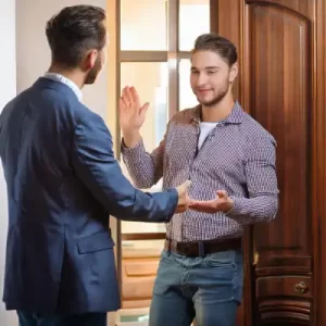 A man greets another that enters a drug rehab in canada