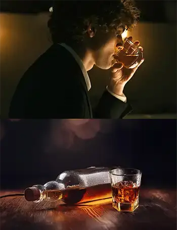  A man drinking alone and a bottle of whisky.