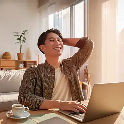Man at a laptop smiling.