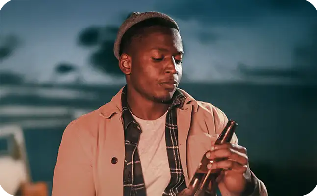 a man holding a beer.