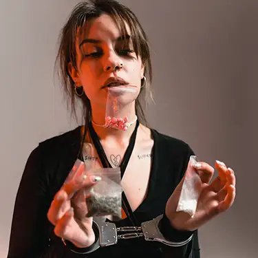a woman holding many different drugs